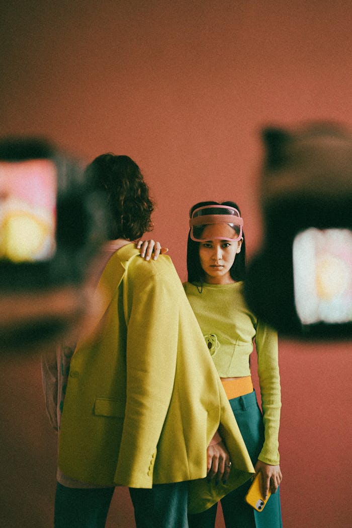 Stylish portrait of young adults in fashion-forward attire in a studio setting.